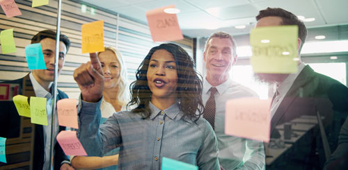 Team brainstorming with colorful sticky notes.