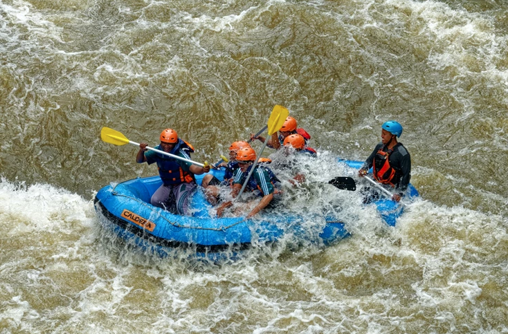 People white water rafting.